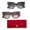 Sunglasses with burgundy case by Two's Company